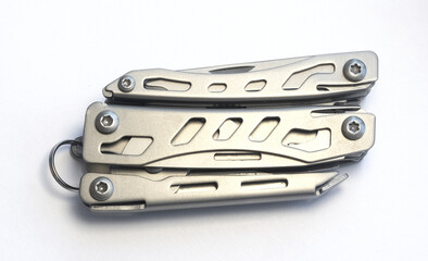 Miniature, pocket-sized universal Multi tool containing a knife, opener, pliers, scissors and  file.