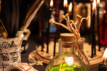 Witchcraft table set, selective focus at potion vial or glass bottle with magic liquid ingredient....