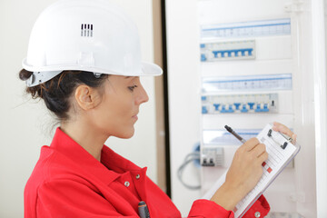 female electrician reading the electric meter