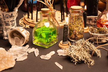 Fototapeta na wymiar Witchcraft table set, selective focus at potion vial or glass bottle with magic liquid ingredient. Alchemy and esoteric items for magic cult at the background. Spiritual occultism and magic chemistry