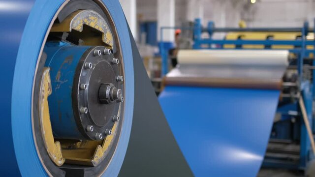 Production line of metal profile at modern metalwork Industry factory. Automated industrial machine processing metallurgical products, equipment, manufacturing, Galvanized steel sheet, roof, facade