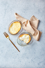 Delicious cottage cheese casserole in portioned glass forms with sour cream. Traditional Russian cuisine for breakfast - Zapekanka
