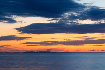 Sunset on Mediterranean sea behind Capraia Island, Tuscany Italy