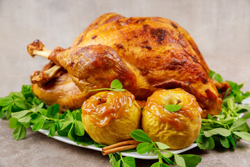 Holiday roasted turkey garnished with caramel apples and clover leaves.
