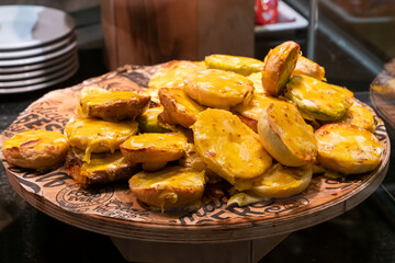 small baguette sandwiches with baked melted cheese on top, on the distribution in the bakery buffet, snack