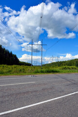 A high-voltage power line runs through the track. Electric pole energized. Vertical photo.