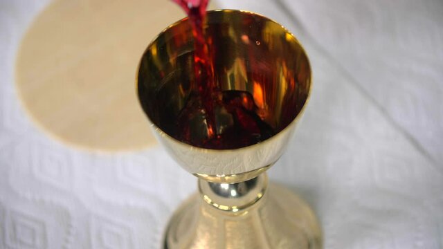 low mo pouring wine into goblet eucharist cavanah bread communion pope peter chris