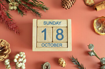 October 18, Cover design with calendar cube, pine cones and dried fruit in the natural concept.