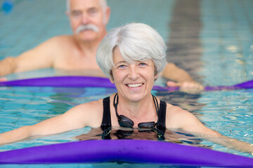 healthy active senior woman swimming in the pool