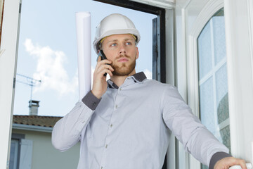 architect on telephone as he enters a property
