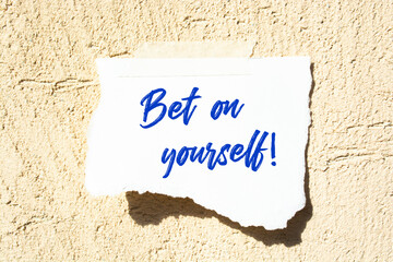 Text bet on yourself on the short note texture background