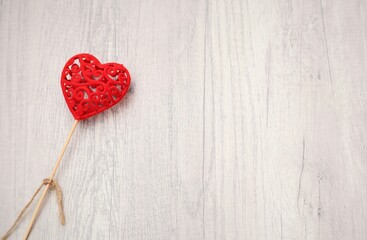 A RED HEART ON A BACKGROUND OF WOOD. VALENTINE´S DAY,  SPACE FOR TEXT