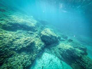 Underwater view of rocks and sand in Alghero coast