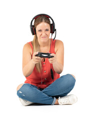 Young woman playing videogames with a controler and a headphones in a white background