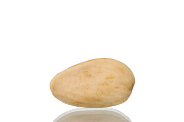 Fototapeta na wymiar One unpeeled pistachio, close-up, isolated on white.