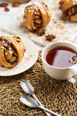 Fresh vegan cinnamon buns on marble board and white marble table