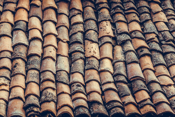 Dirty old roof tiles on a house