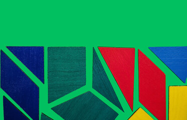 Abstract background.Geometric shapes in different colors on a green background. The concept of logical thinking.