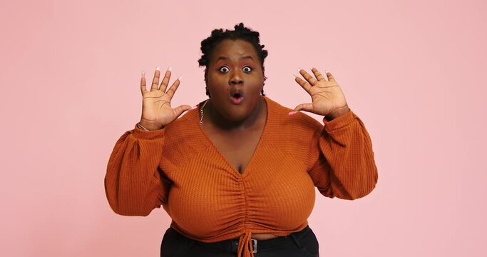 Plump black lady demonstrates surprised face expression