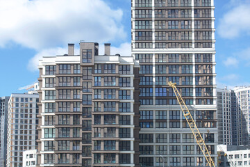 Construction of modern multi-storey buildings. Construction of a new city block. Buildings under construction and tower cranes.