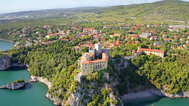 4k drone flight moving up and to the side footage (Ultra High Definition) of Duino Castle. Wonderful morning scene of Adriatic coast of Italy, Europe. Traveling concept background..