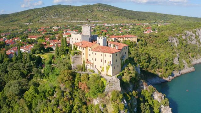 4k drone flight point of view (Ultra High Definition) of Duino Castle. Picturesque morning scene of Adriatic coast of Italy, Europe. Beautiful summer scenery. Traveling concept background..