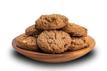 Pile of chocolate chip butter cookies in wooden plate on white background.