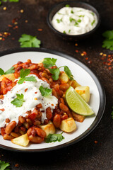 Spicy Bean Chilli with Baked Potato, sour cream and lime. Healthy Food