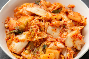 Traditional Korean Kimchi Cabbage in white bowl. Healthy food.