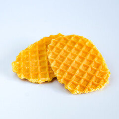 Waffles orange white and striped plate on background.