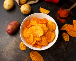 Paprika Potato Chips in white bowl on rustic background