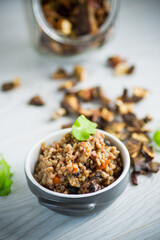 boiled buckwheat with vegetables and dried forest mushrooms in a ceramic mold