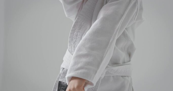 Sports uniform for karate. The girl is dressed in a kimono.