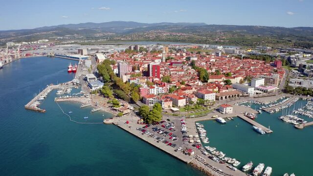 4k drone flight moving up and to the side footage (Ultra High Definition) of Koper port. Colorful summer scene of Adriatic coastline, Slovenia, Europe. Picturesque Mediterranean seascape.
