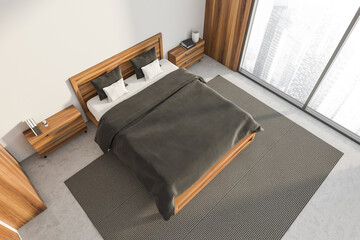 Top view on bright bedroom interior with empty white wall