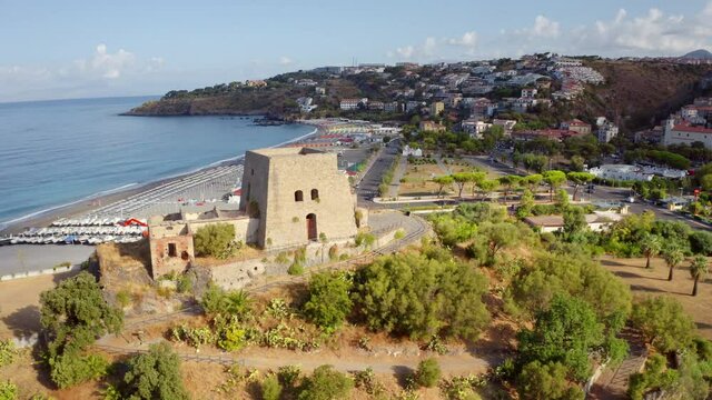 4k drone flight moving to the side footage (Ultra High Definition) of historical place - Talao Tower. Colorful morning cityscape of Scalea town, Province of Cosenza, Italy. 