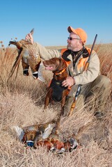 A hunter with a brace of pheasants 