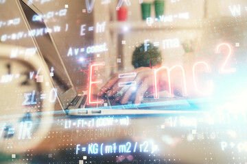 Double exposure of woman hands typing on computer and formula hologram drawing. Education concept.