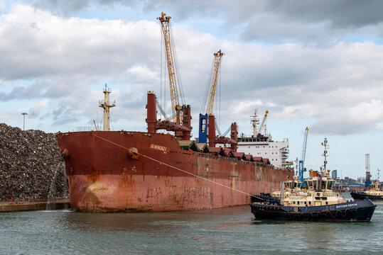 Southampton, England, UK. 2021.  Tug manoeuvres a bulk carrier ship towards her berth in the port of Southampton a British port.Southampton.