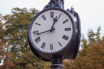 Metal dial on a street clock. Ternopil, Ukraine