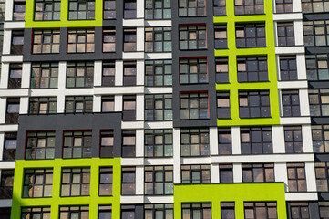Fototapeta na wymiar Wall of a modern new building with windows. Beautiful juicy colored building texture for background