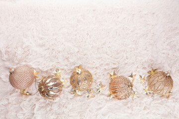 Golden christmas balls with wool background.