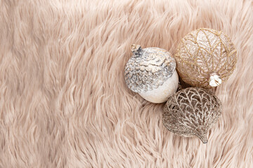 Golden christmas balls with wool background.