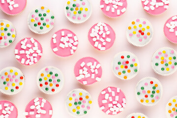 Colorful cupcakes on a white background.