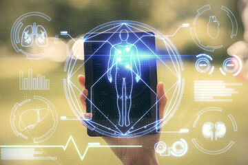 Double exposure of education theme sketch hologram and woman holding and using a mobile device.