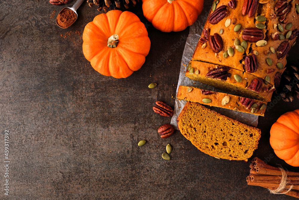 Aufkleber fall pumpkin bread sliced. top view table scene over a dark background. copy space.