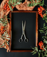Autumn still life with rowan, vintage scissors in the frame and orange cloth. Peach fuzz flatlay.