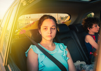 portrait of a beautiful sad teen girl in the car