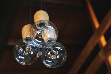 Fototapeta na wymiar Retro luxury lamps of Edison. Lighting decor in modern wooden house.
