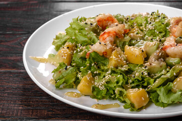 Delicious fresh salad with shrimp and pear for the festive table
